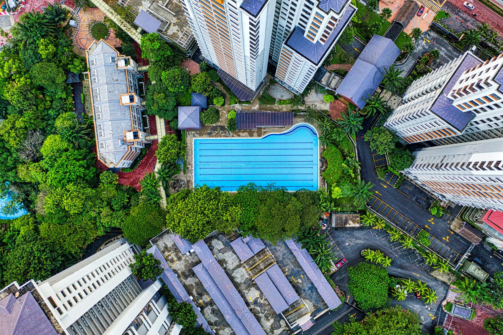 Aerial view of a condominium pool and grounds, representing a new launch